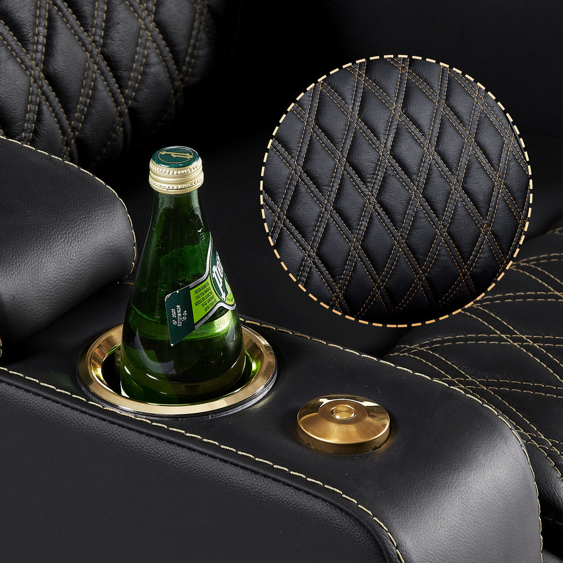 Close up of black upholstery with gold stitching and gold finished cup holder detail