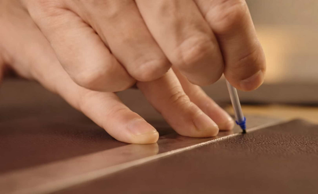 Close-up of skilled hands stitching leather upholstery, highlighting craftsmanship in home theater seating